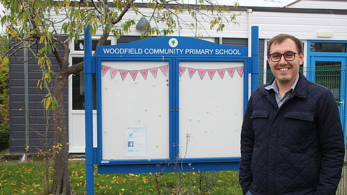 Tom Gordon MP stood in front of Woodfield Primary School 