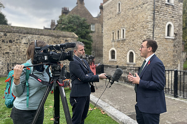 Tom Gordon MP stood speaking to the press of College Green outside Parliament