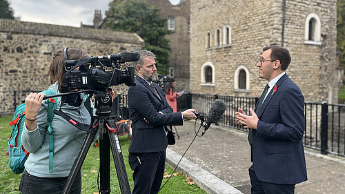 Tom Gordon stood on College Green near the houses of Parliament talking to the press