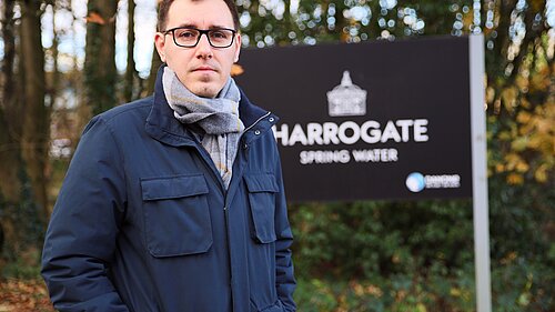 Tom Gordon stood by a Harrogate Spring Water sign