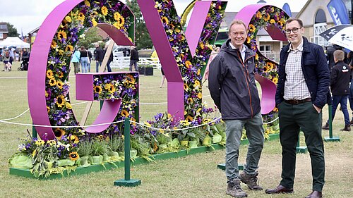 Tom Gordon with Tim Farron MP in front of a large 3D sign reading "GYS" at the Great Yorkshire Show in Harrogate