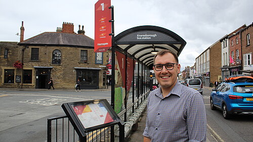 Tom at bus stop