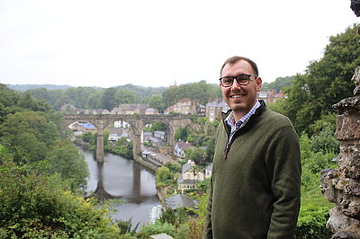 Tom Gordon MP stood in front of view of Knaresborough Viaduct