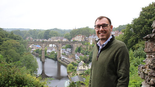 Tom Gordon MP stood with view of Knaresborough viaduct behind him