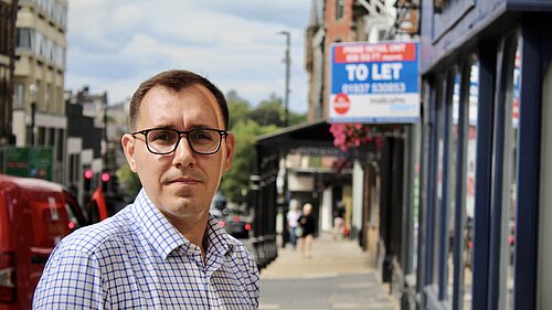 MP Tom Gordon stood outside empty high street shop with TO LET sign