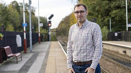 Tom Gordon MP at a train station.