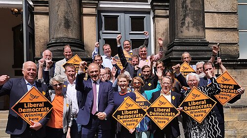 Tom Gordon amongst other liberal democrats including Ed Davey, all holding LD signs