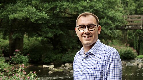 Tom Gordon MP standing in front of a river