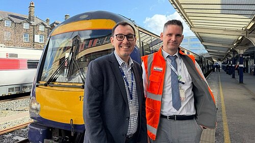 Tom Gordon stood by a train at Harrogate station