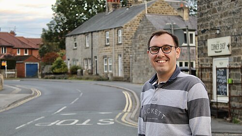 Tom gordon MP on street corner 