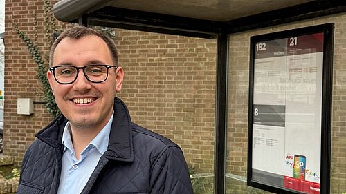 Tom Gordon stood at a bus stop