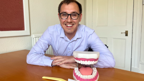 Tom Gordon MP Sat with model of teeth and toothbrush