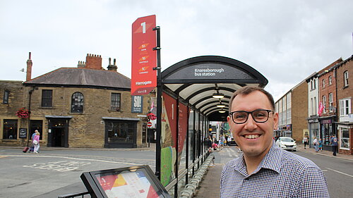 Tom Gordon MP at a bus stop in Knaresborough