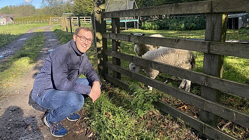 Tom Gordon next to a sheep
