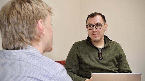 Tom sat talking to a constituent