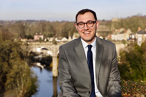 Tom Gordon stood overlooking the Nidd Gorge with Knaresborough viaduct behind him