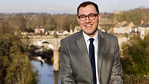 Tom Gordon stood overlooking the Nidd Gorge with Knaresborough viaduct behind him