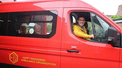 Tom Gordon MP sat in the driver's seat of the Happy Wanderers mini bus