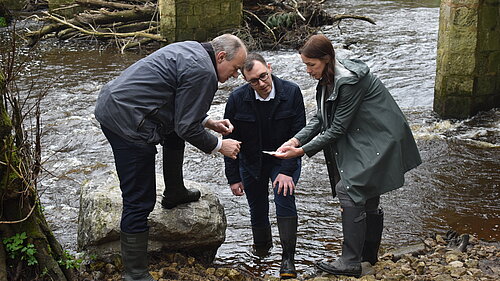 Tom Gordon with Cllr Hannah Gostlow and Ed Davey testing the water in the River Nidd