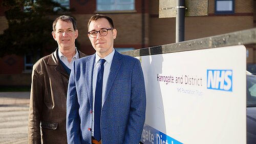 Tom Gordon and Pater Lacey stood infront of NHS sign